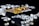A collection of sparkling, clear gemstones surrounds a dark surface featuring the prominent logo and text 'Real Poker.' The logo design includes gold and white elements set against a black background.