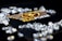A collection of sparkling, clear gemstones surrounds a dark surface featuring the prominent logo and text 'Real Poker.' The logo design includes gold and white elements set against a black background.