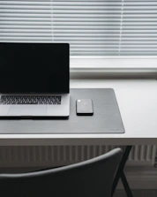 Modern minimalist workspace with a smartphone showing a WhatsApp chat ready for contact.