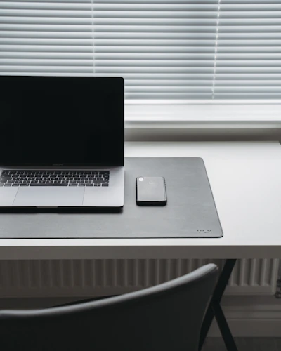 A minimalist workspace with a smartphone showing digital asset options
