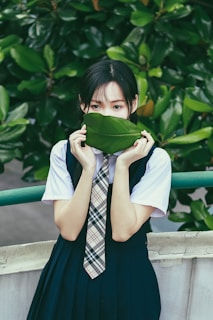 A student engaged in a nature science experiment outdoors with greenery in the background