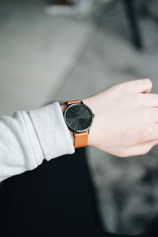 Close-up of a men's wrist wearing a sleek, colorful watch from timehue against a casual outfit.