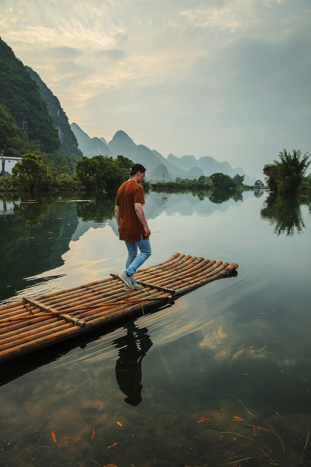 man walking on bamboo dock during daytime