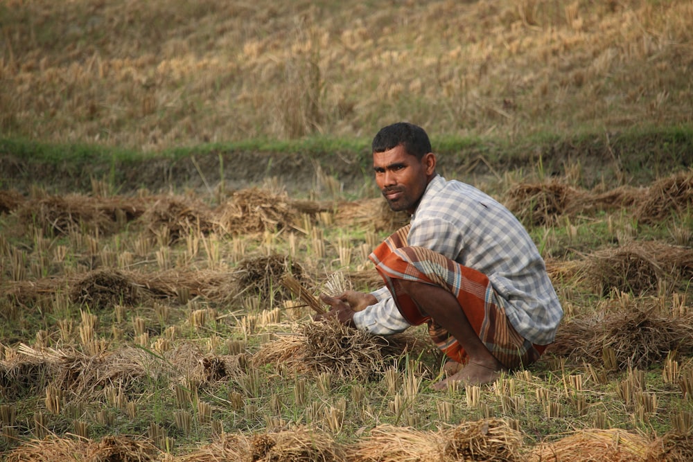 man sitting on grass field