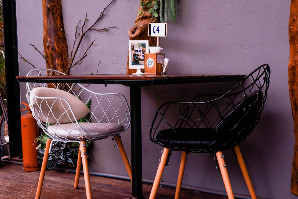 two black and white metal padded chairs