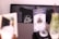 A blurred image of a café setting with a black cushioned bench. In focus is a pillow with white cursive writing that says 'day 2 night'. Nearby objects are out of focus, including a menu or flyer and a bottle with a straw.