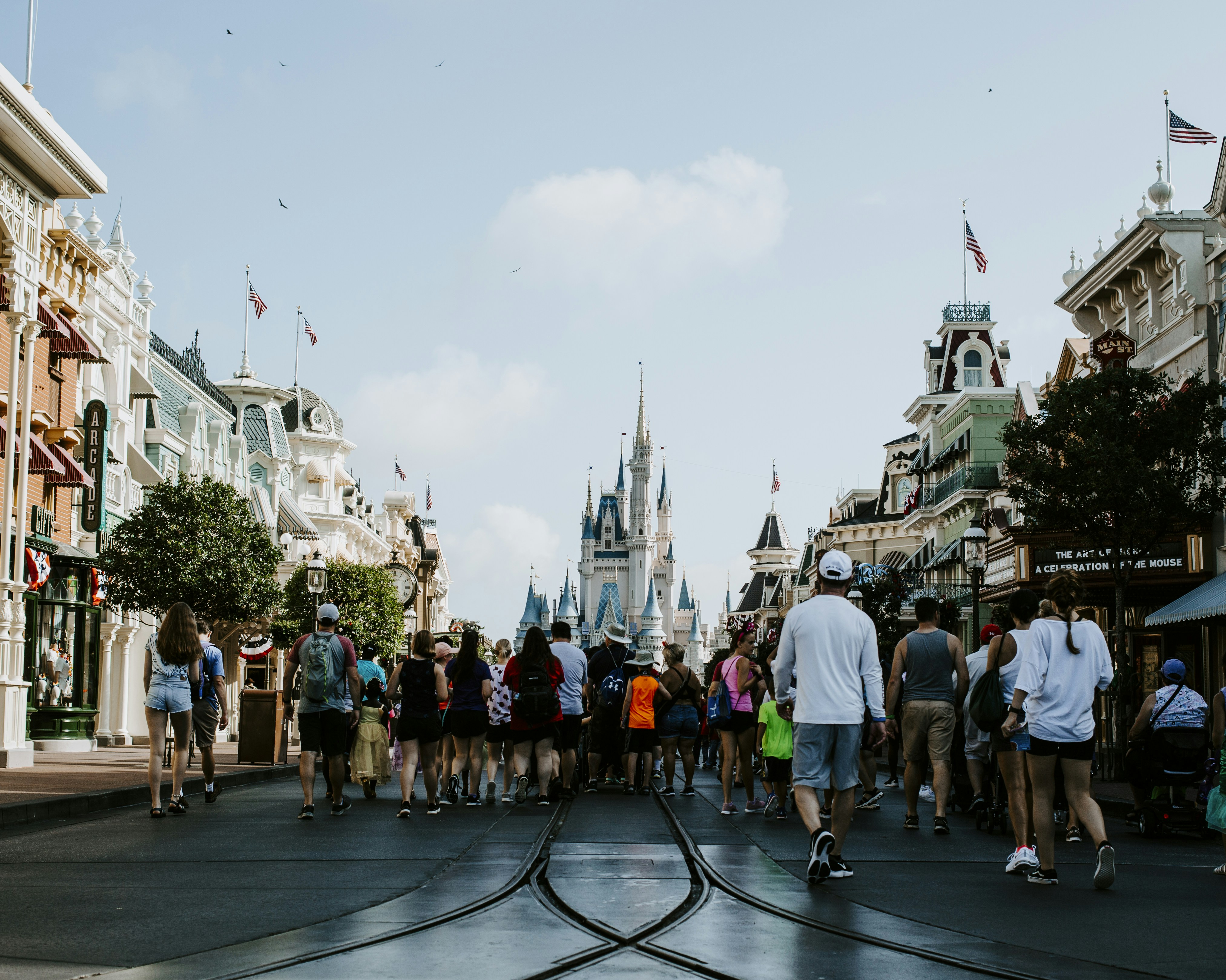 people standing in front of white and blue castle