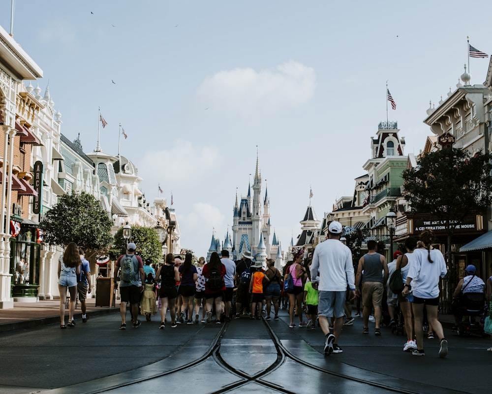 people standing in front of white and blue castle