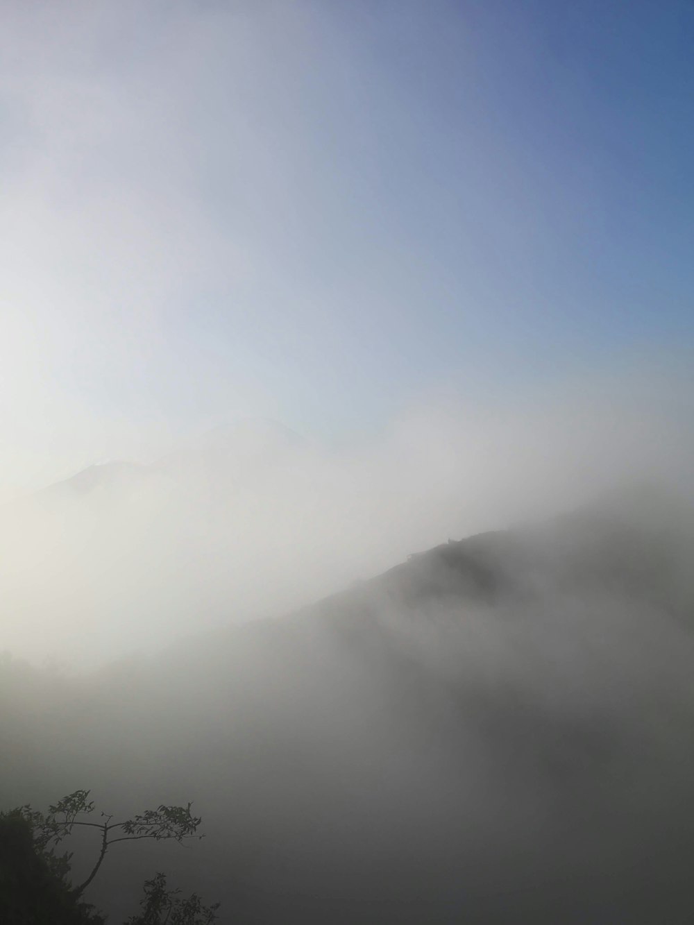 black mountain covered by white clouds