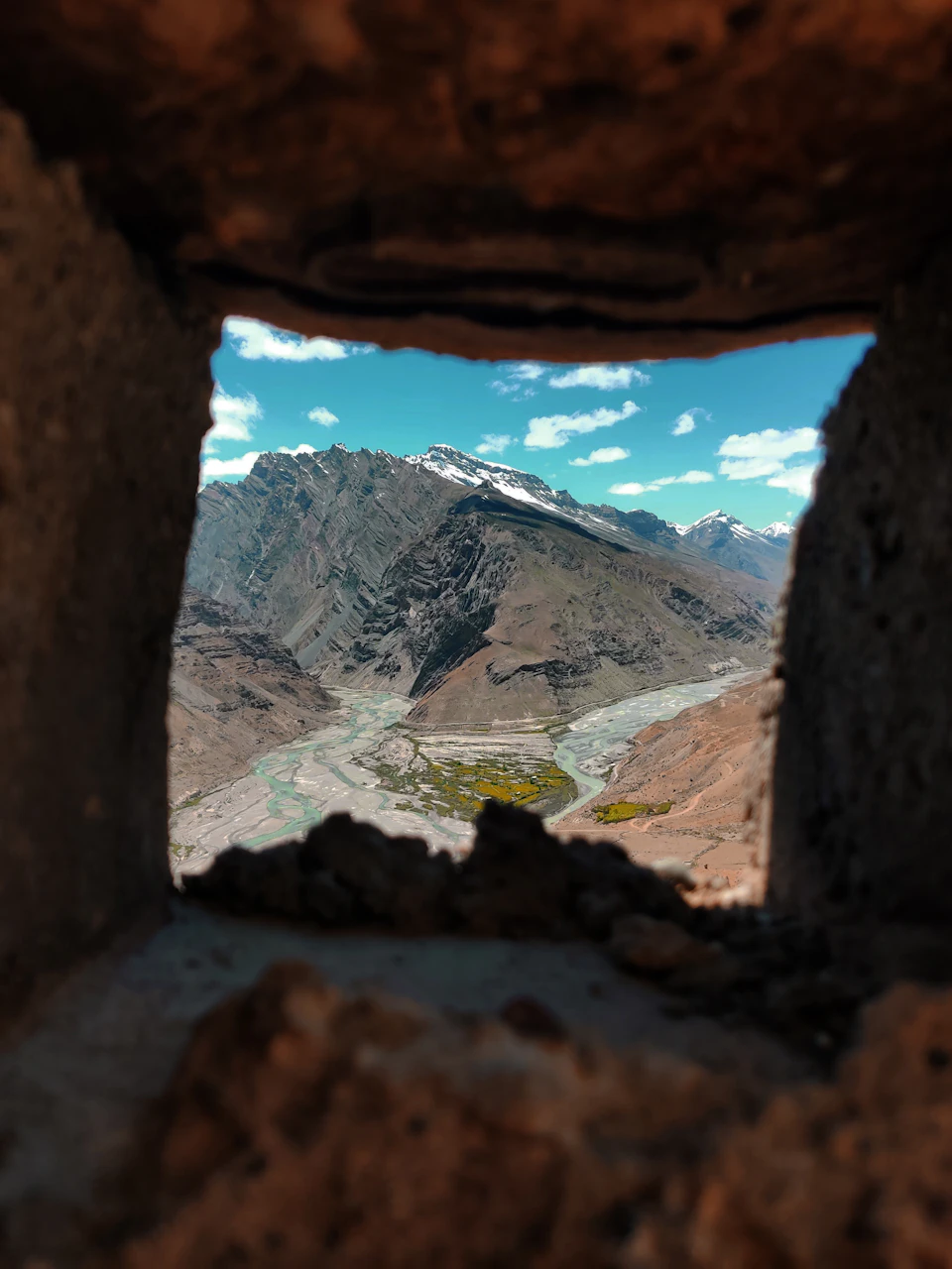 Breathtaking view from an opening in a stone wall frames panoramic landscape scenery