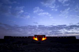 A beautifully restored Omani fortress bathed in warm sunset light.