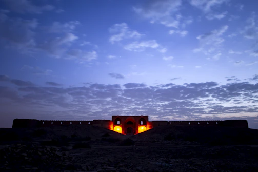 A beautifully restored Omani fortress bathed in warm sunset light.