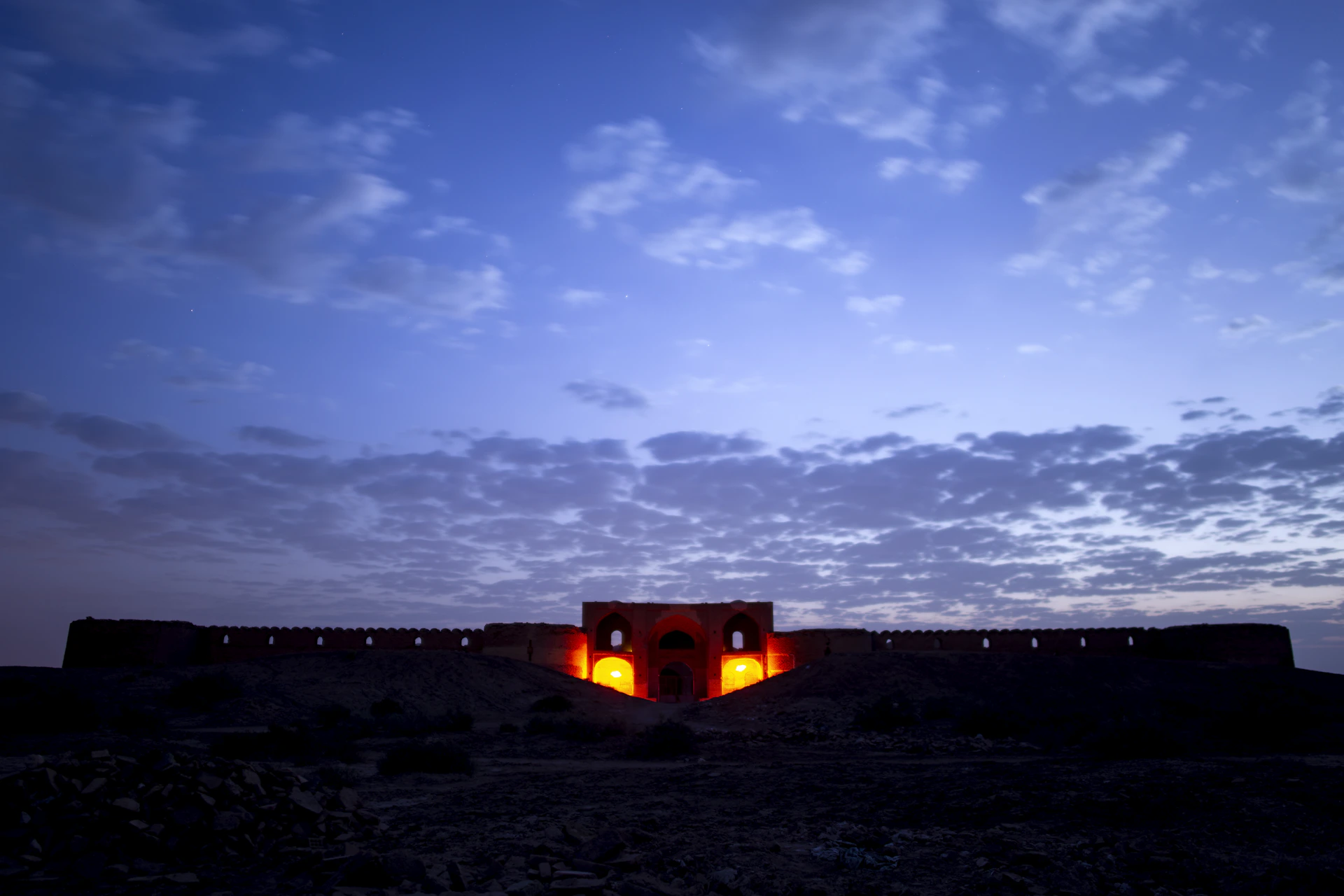 A vibrant photo of Afyonkarahisar's historic castle bathed in warm sunset light, highlighting its ancient stone walls.