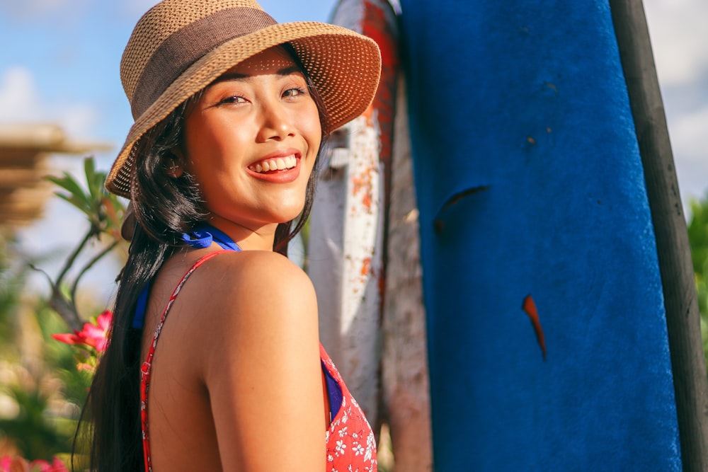 woman wearing sun hat and floral top