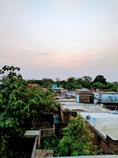 A rural village with digital connectivity icons floating above.