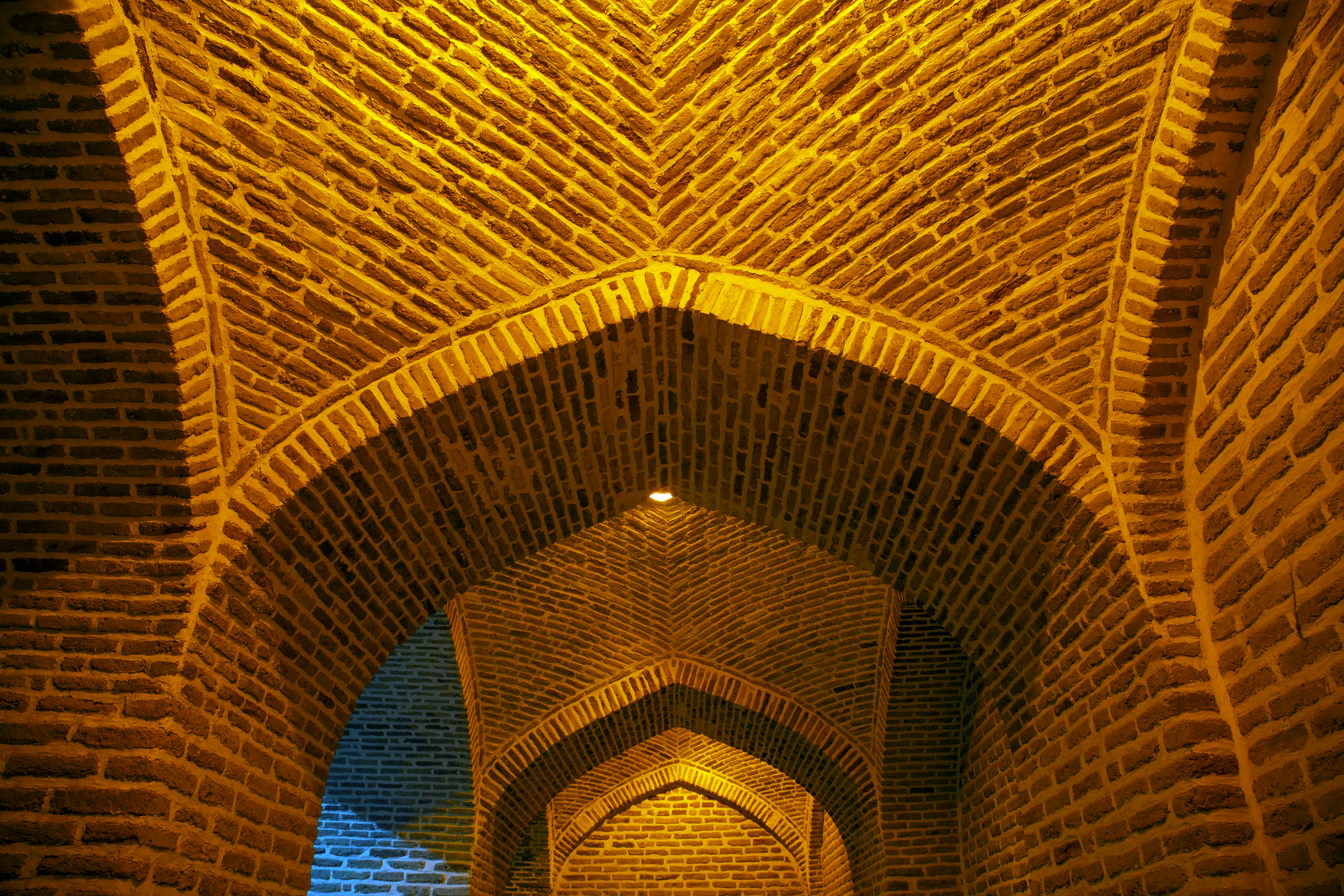 Ancient Indian archaeological ruins, warm golden light, stone brick structures, dry landscape