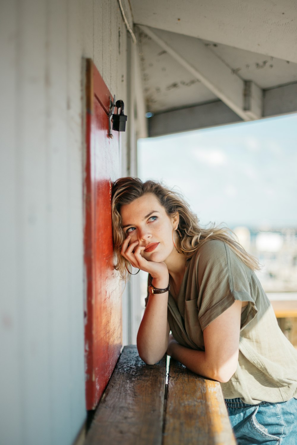 woman leaning on brown table