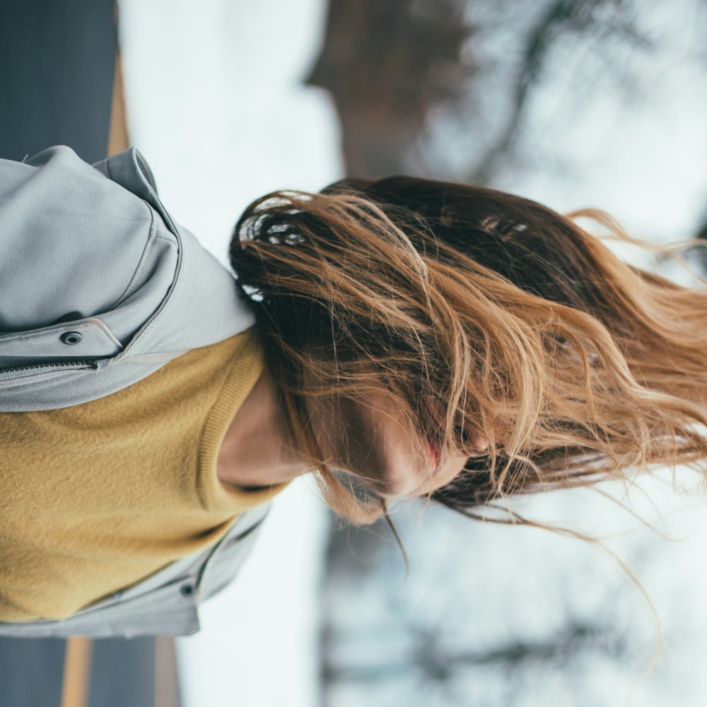 woman in gray jacket on selective focus photography