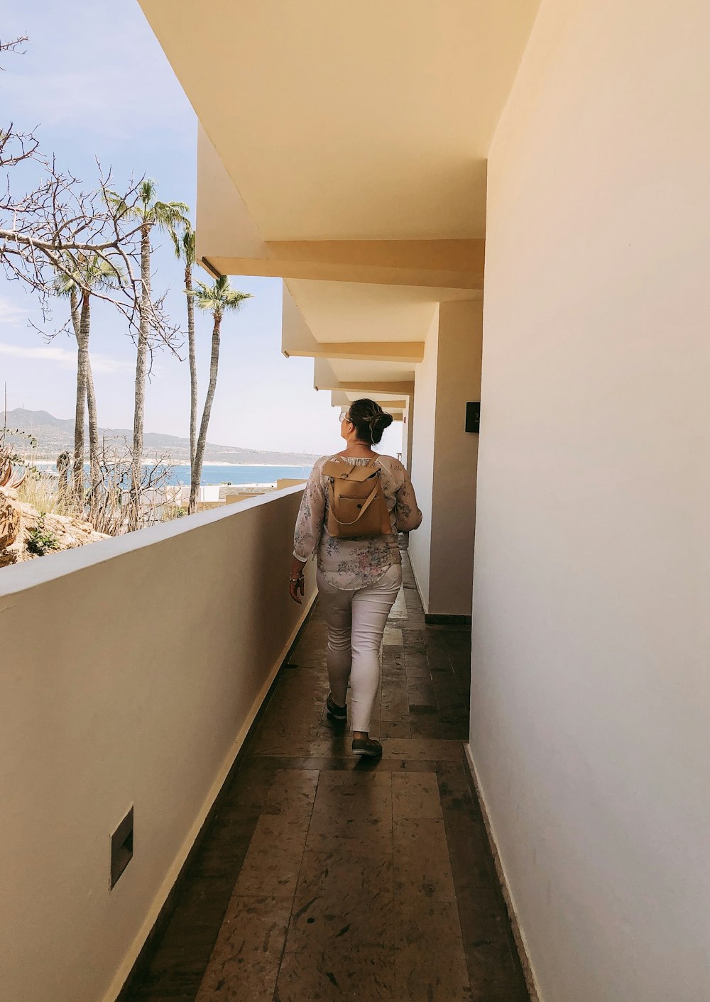 woman walking near walkway inside building