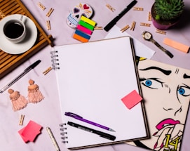 A cozy workspace with handmade semi-precious stone jewelry and a handwritten note.