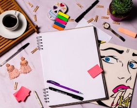 A vibrant flat lay of a notebook, camera, and colorful mood board for content creation.