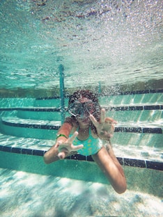 person swimming under water during daytime