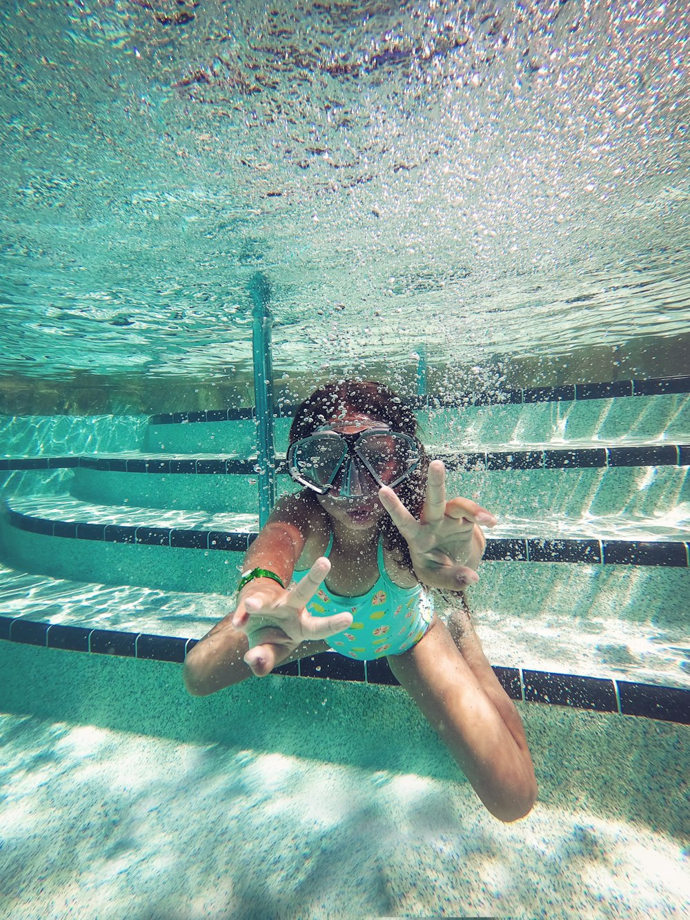 person swimming under water during daytime