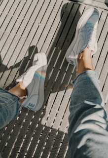 Casual outfit featuring light blue jeans and white sneakers outdoors