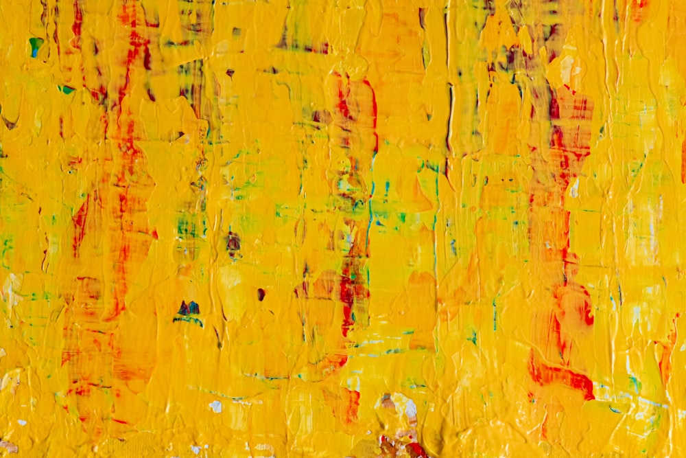 an abstract painting with yellow and red colors