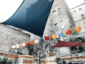 Sunlight filtering through paper lanterns over a traditional courtyard where music blooms.