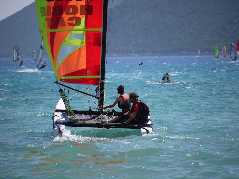 two person riding sailboat during daytime