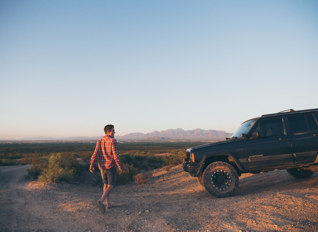 man standing in front of SUV