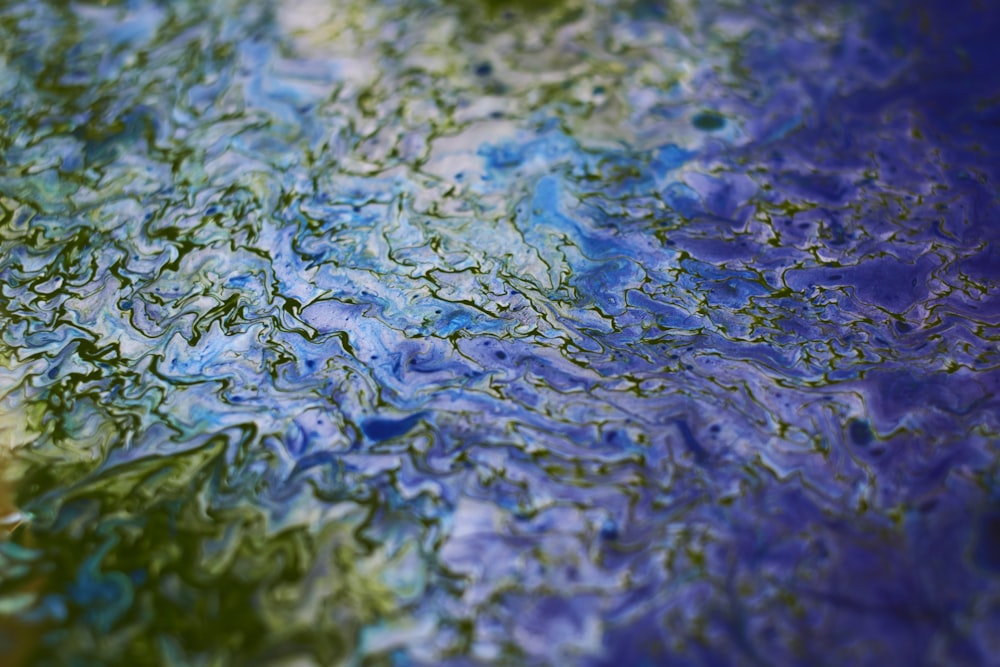 a close up of a blue and green painting