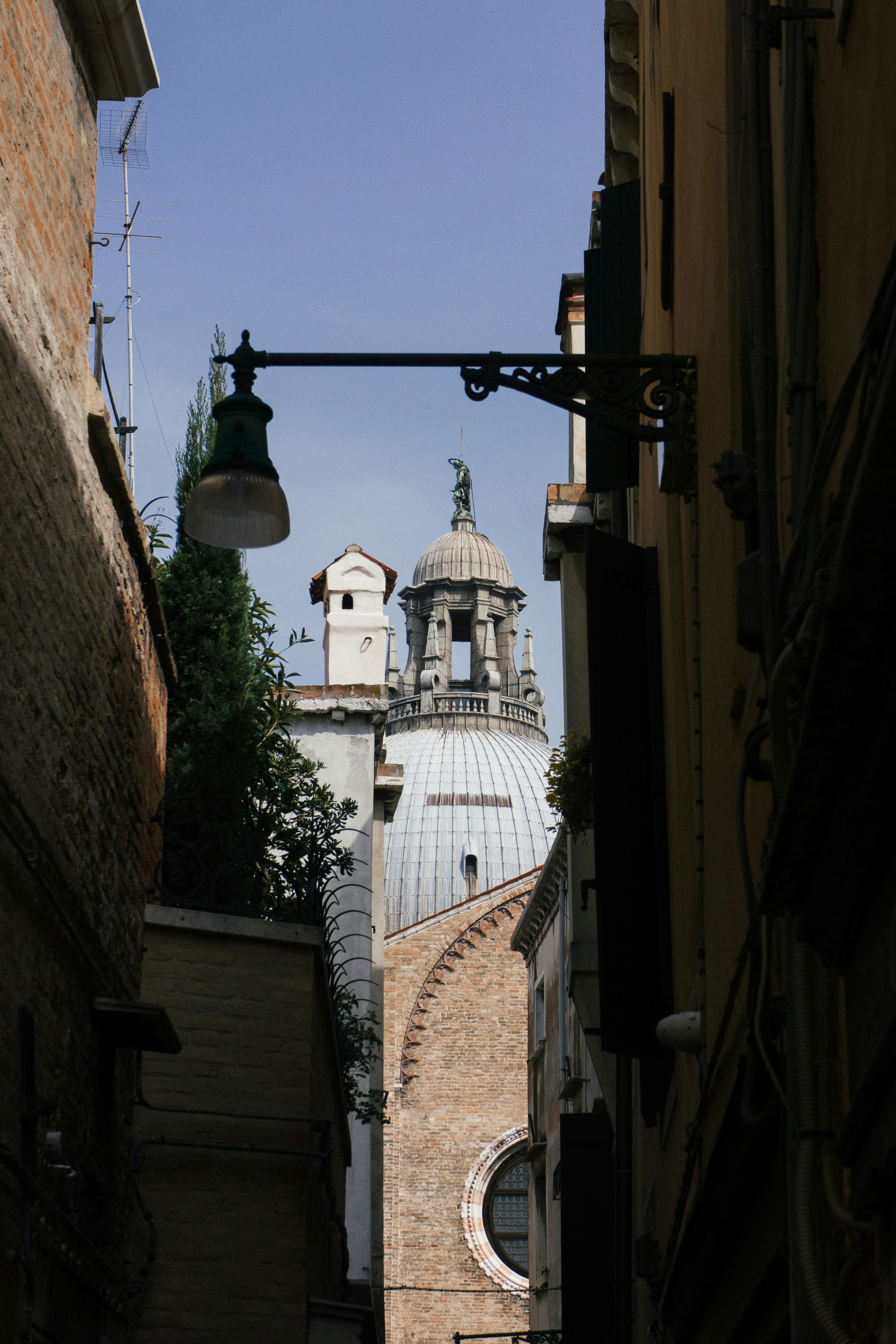 black street wall lamp across white tower