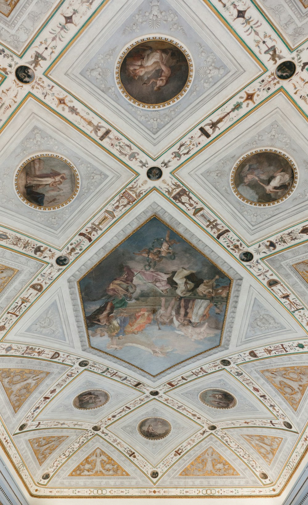 the ceiling of a building with paintings on it