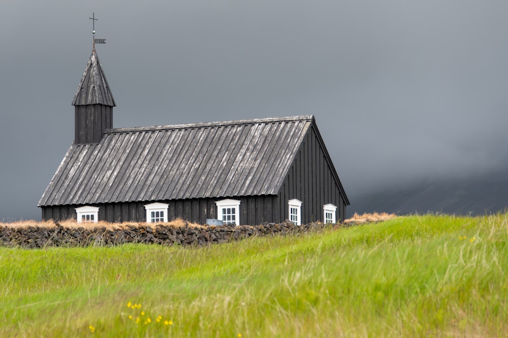 grey church on green field