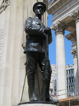 A veteran proudly standing beside a newly built pool, symbolizing dedication and community support.