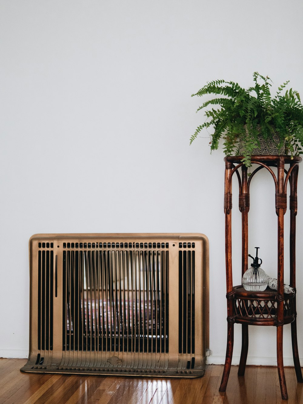 white electric heater besides green plants