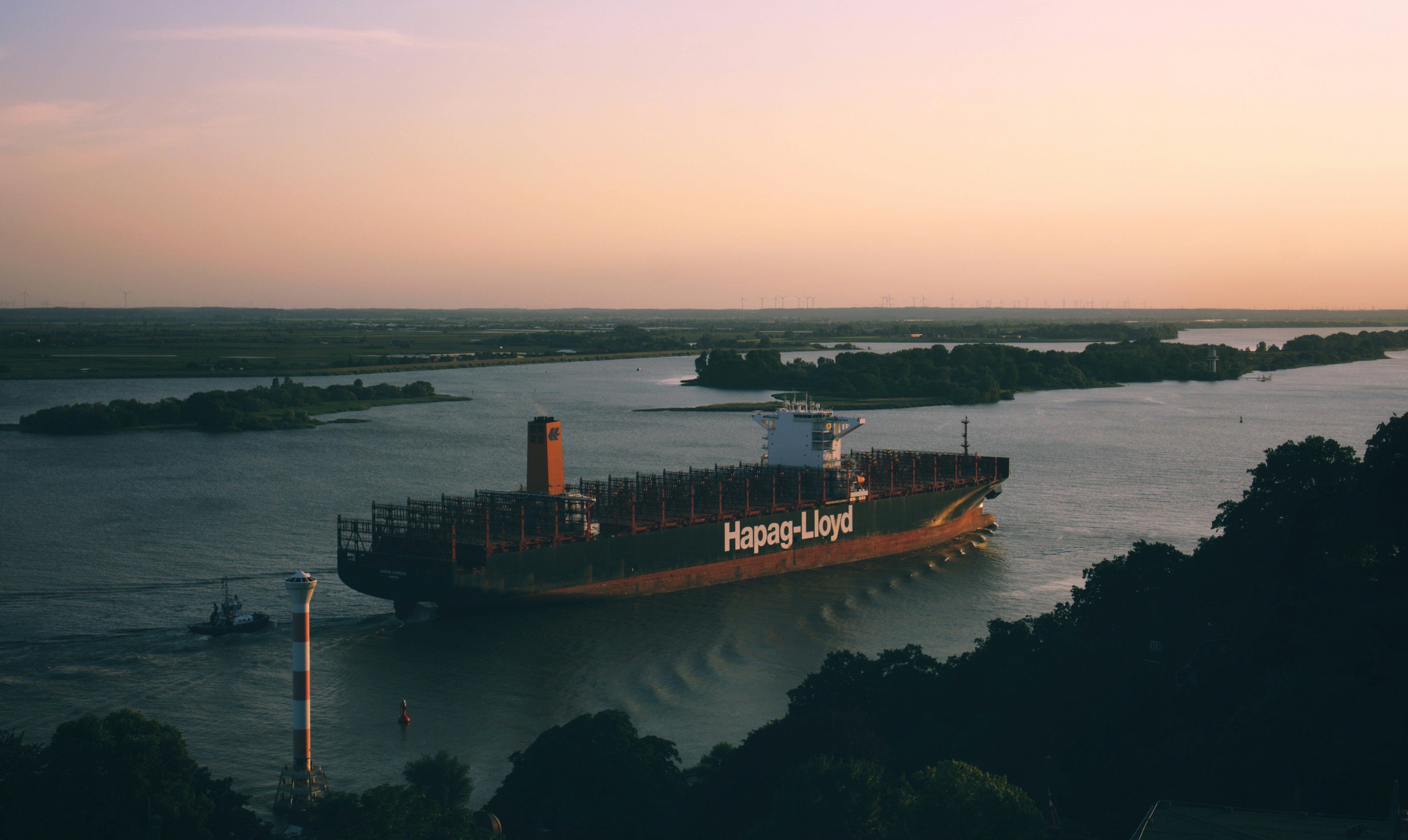 black and orange cargo ship sailing