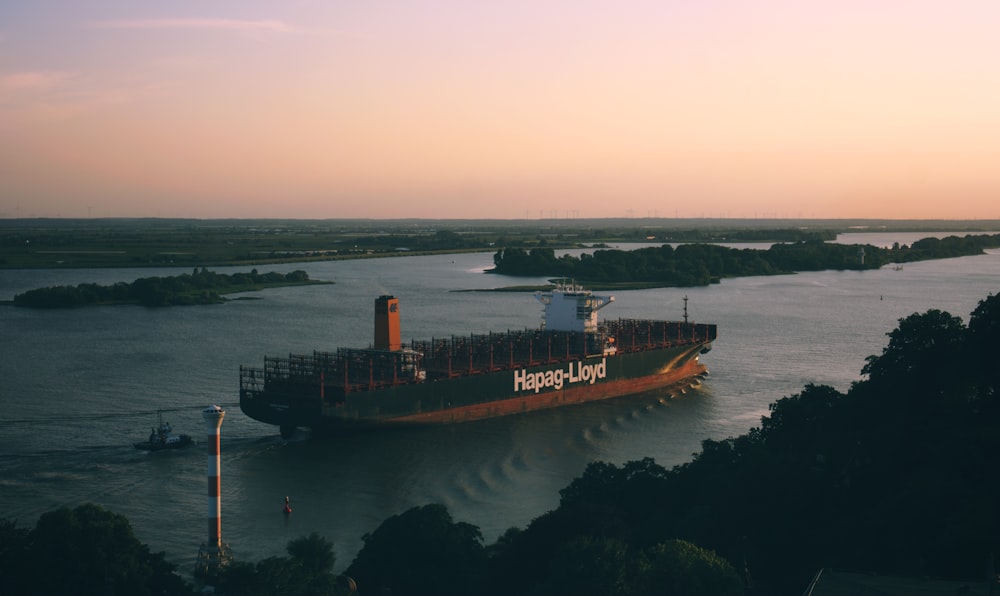 black and orange cargo ship sailing