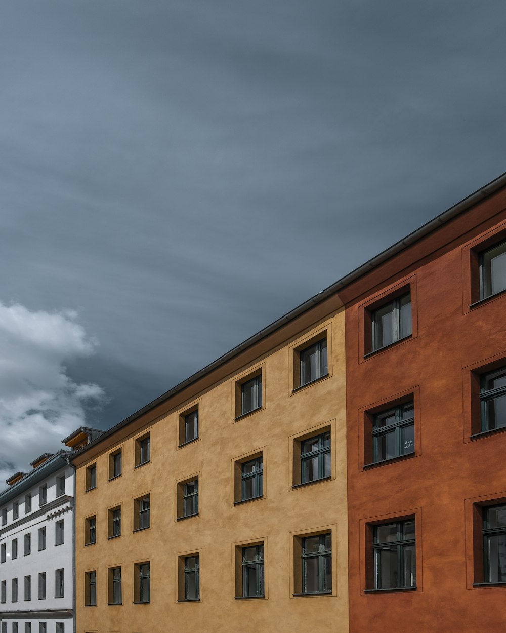 brown concrete building under cloudy sky during daytime