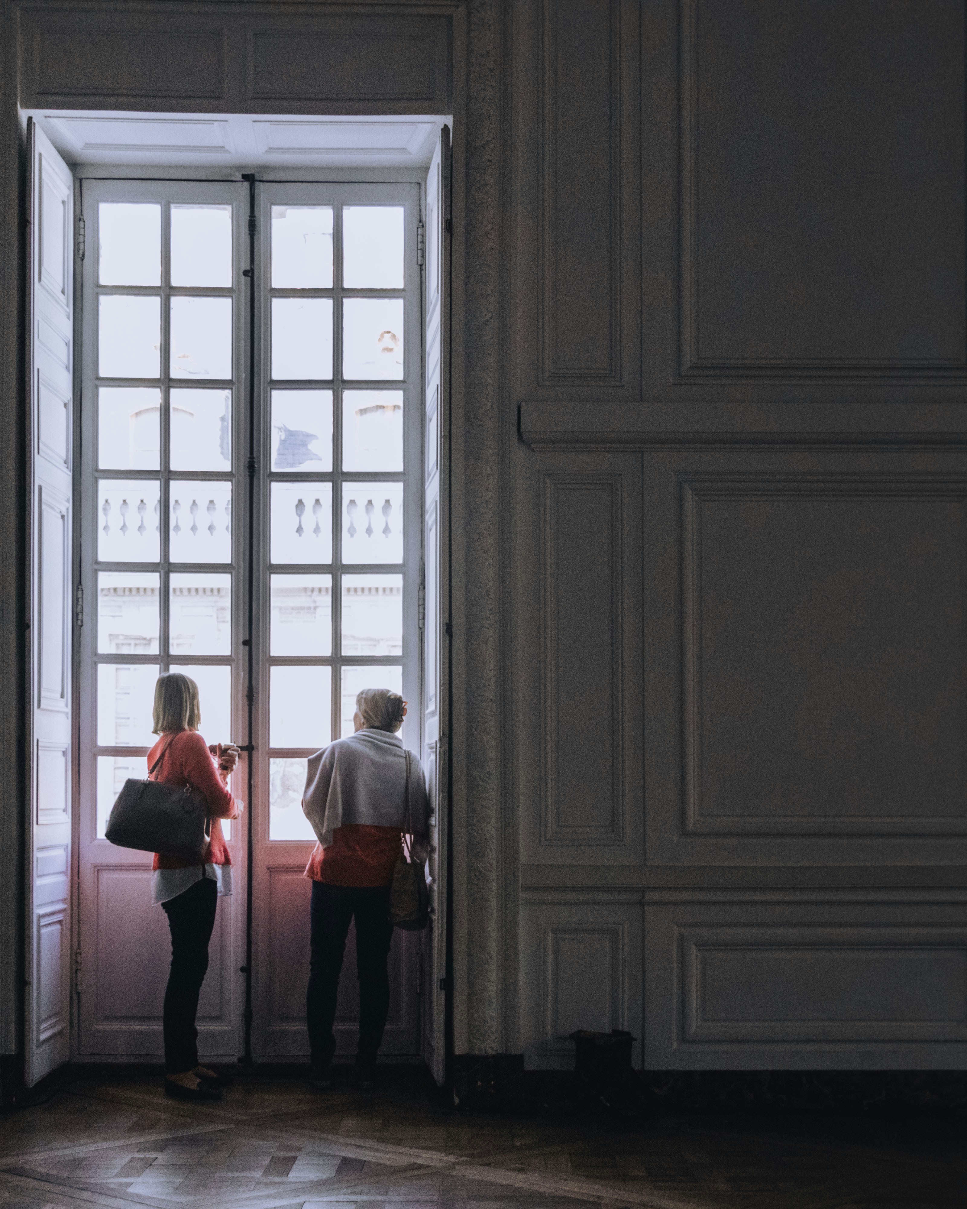 Two person standing in front of door photo – Free Grey Image on Unsplash