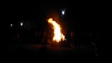 Community members gathered around a bonfire sharing stories and songs.