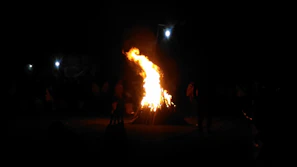 The league gathered around a bonfire at dusk, sharing stories and warmth despite their gruff exteriors.