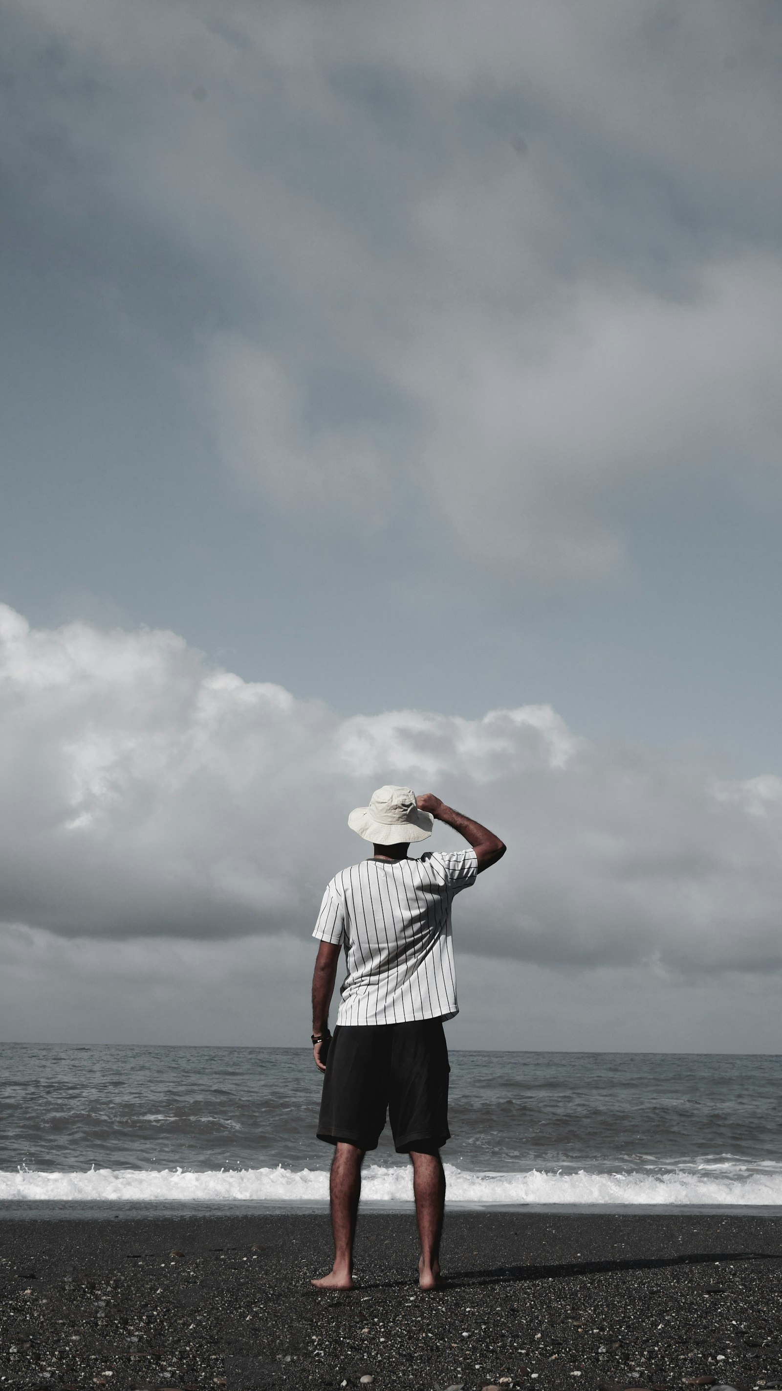 Panasonic Lumix G 20mm F1.7 ASPH sample photo. Man standing on beach photography