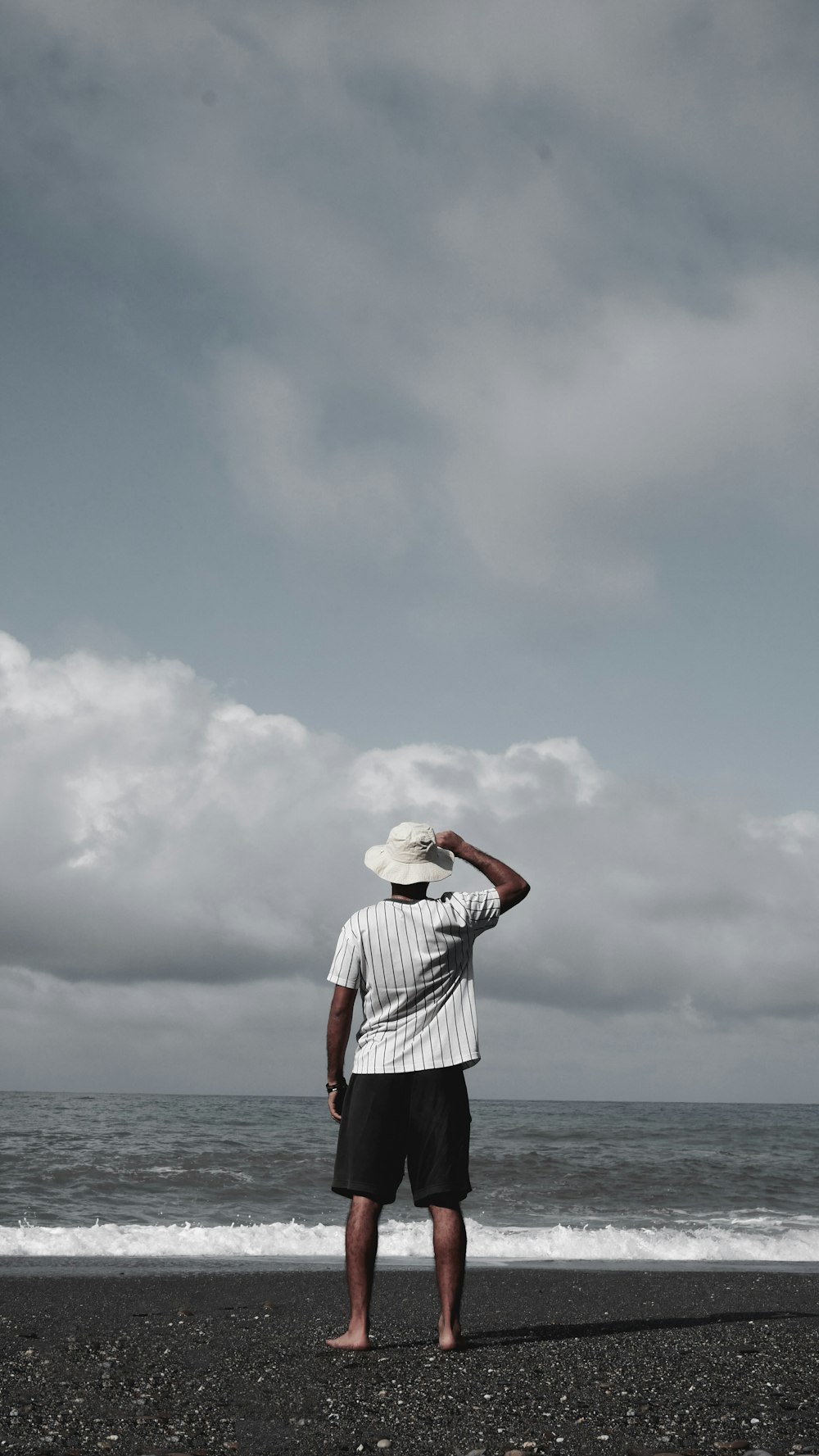 man standing on beach during daytime