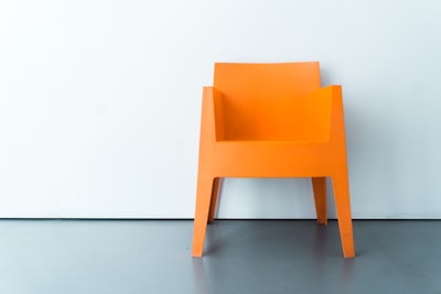 orange plastic armchair chair teams background