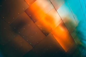 Industrial-grade steel panel with metallic gradient and neon orange accents under harsh lighting.