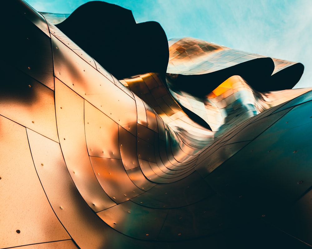 a close up of a metal structure with a sky background