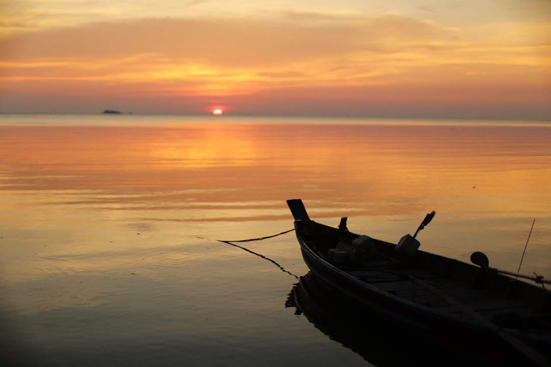 silhouette boat on body of water